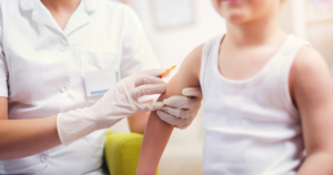 Doctor giving boy vaccine
