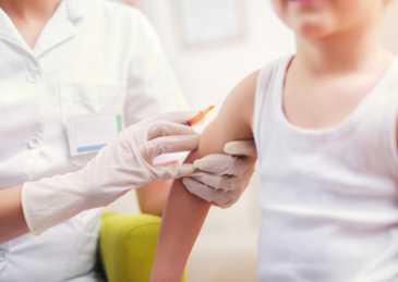 Doctor giving boy vaccine