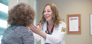 Photo of Marina Roytman, MD, caring for patient